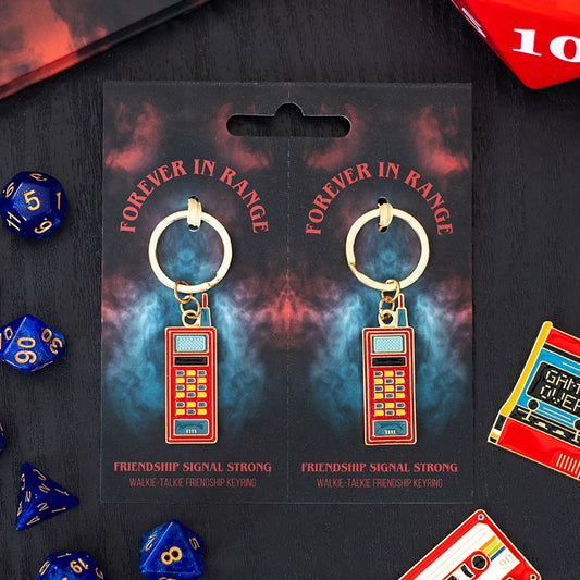 Keychain packaging with 'Forever in Range' text and keychain design on a dark background with dice.