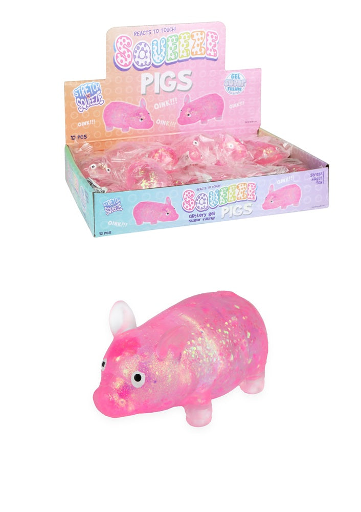 Display box of Squeeble Pigs with a pink glittery pig toy in front