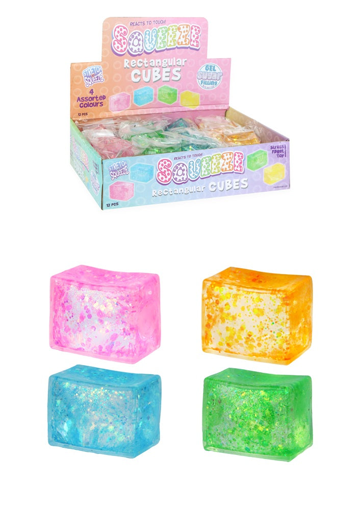 Display box of colourful rectangular sugar squish cubes with four sample cubes on a white background.