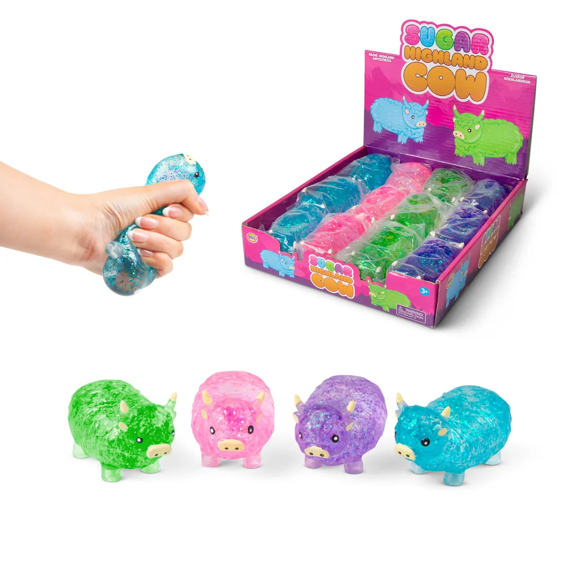 Colorful cow-shaped squishies with a hand holding one, displayed against a white background.