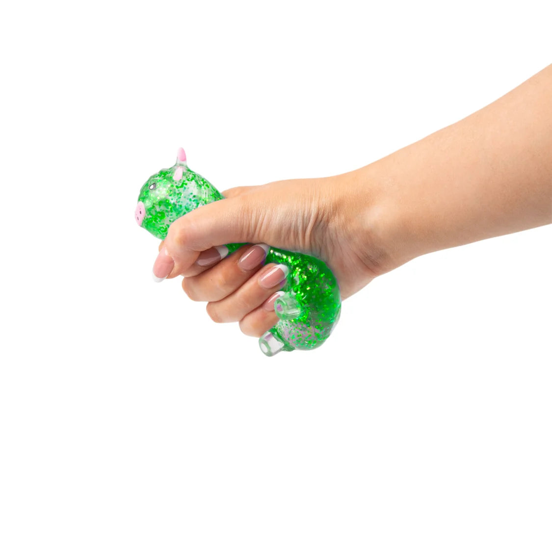 Hand holding a green glittery sugar highland cow against a white background