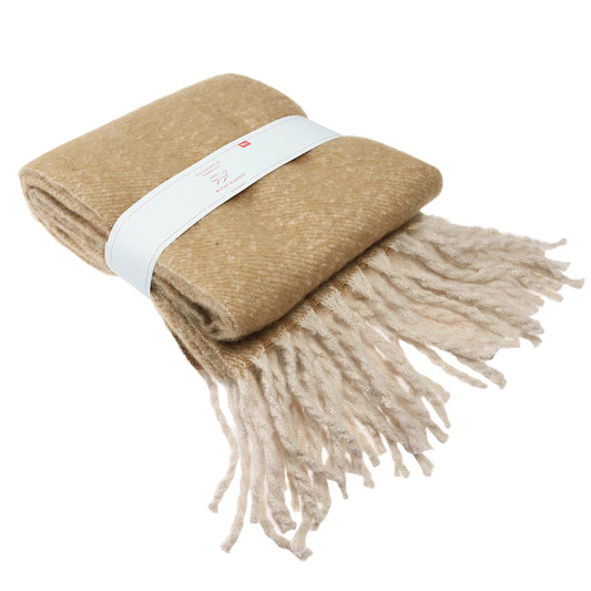Ultra soft and fluffy woven blanket in a soft light brown. folded