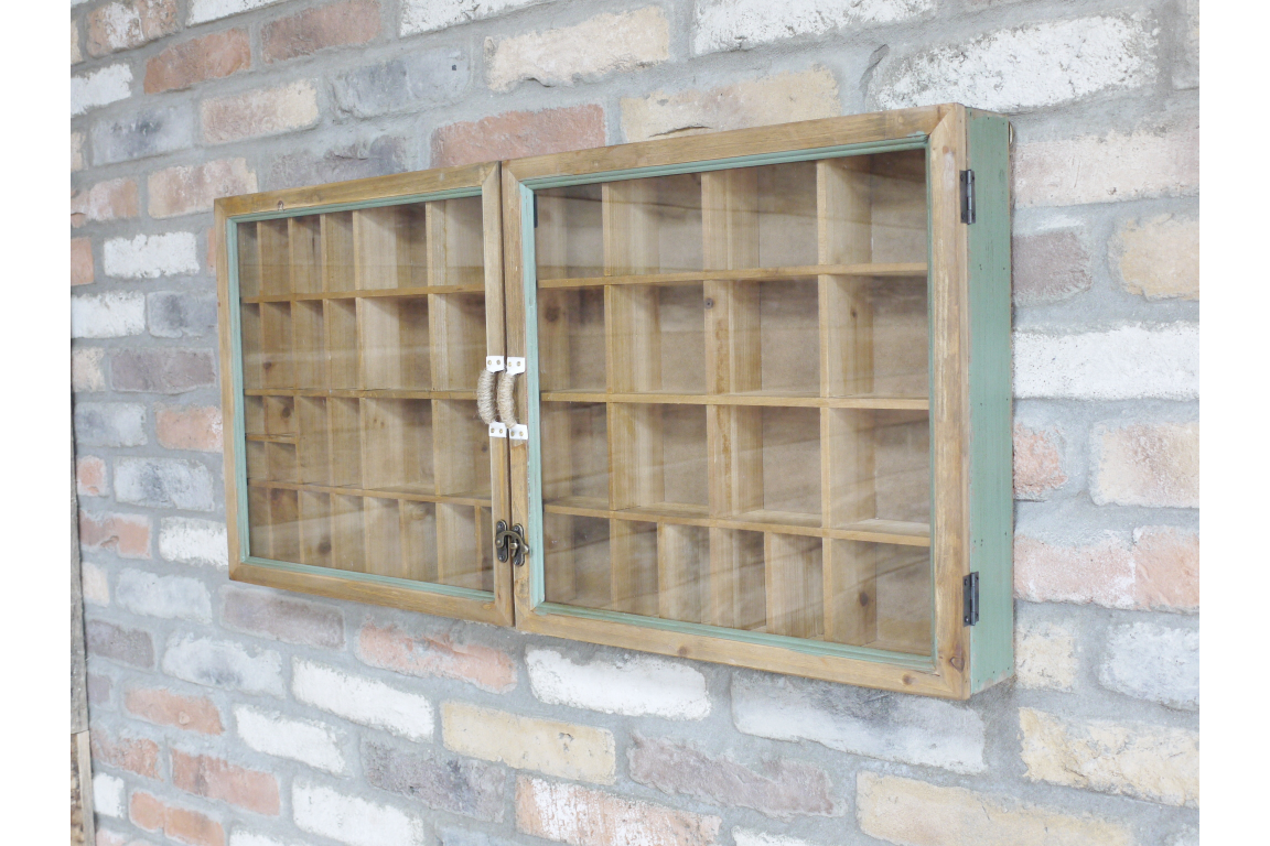 Wooden wall-mounted cabinet with glass doors against a brick wall.