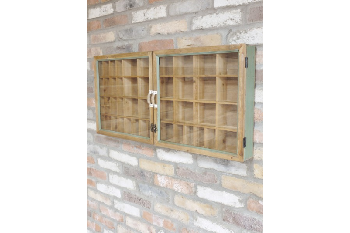 Wooden cabinet with glass doors mounted on a stone wall.