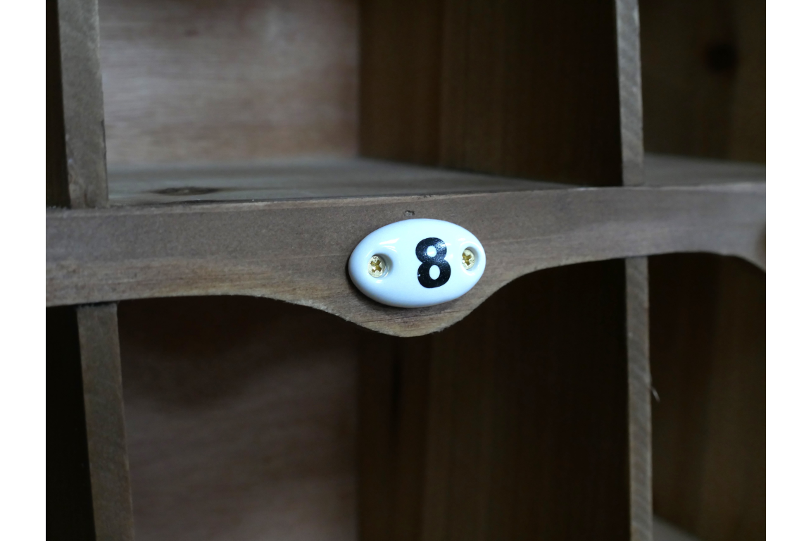 Wooden shelf with a decorative number '8' plaque