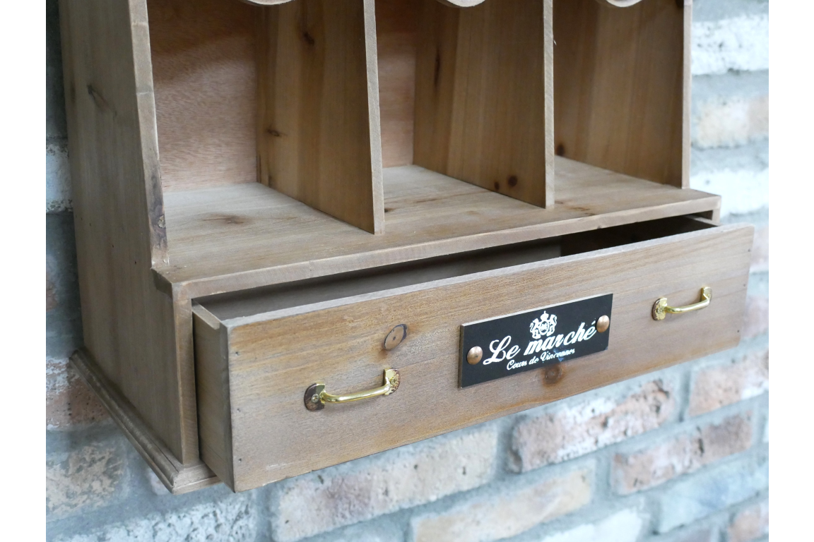 Wooden shelf with a drawer and 'Le Marche' label against a brick wall.