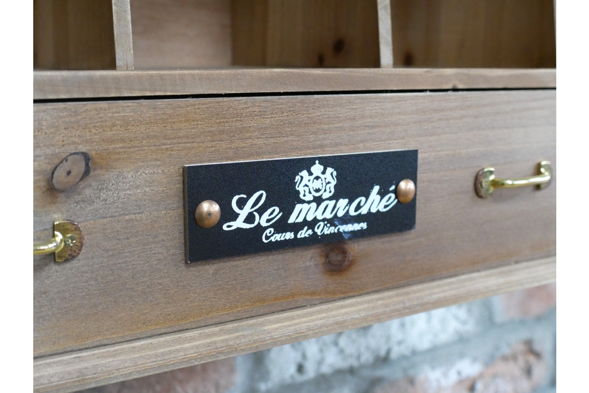 Wooden drawer with 'Le Marché' label and gold handles.