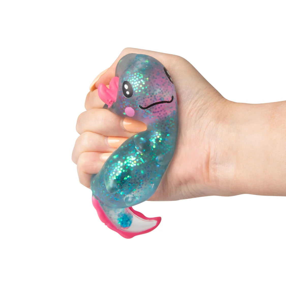 Hand holding a glittery blue and pink squishy toy with a face on a white background