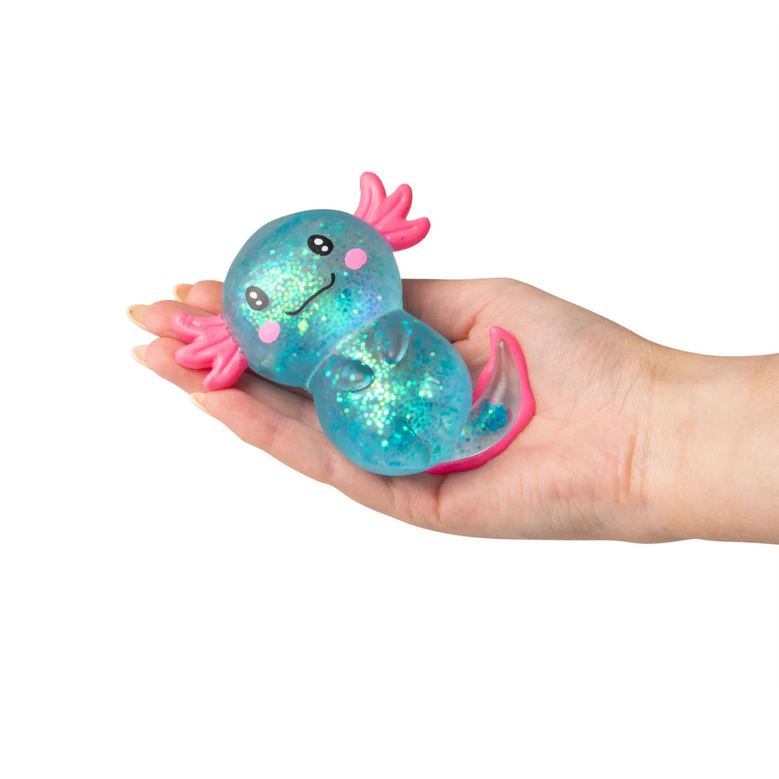 Hand holding a glittery blue and pink creature toy on a white background