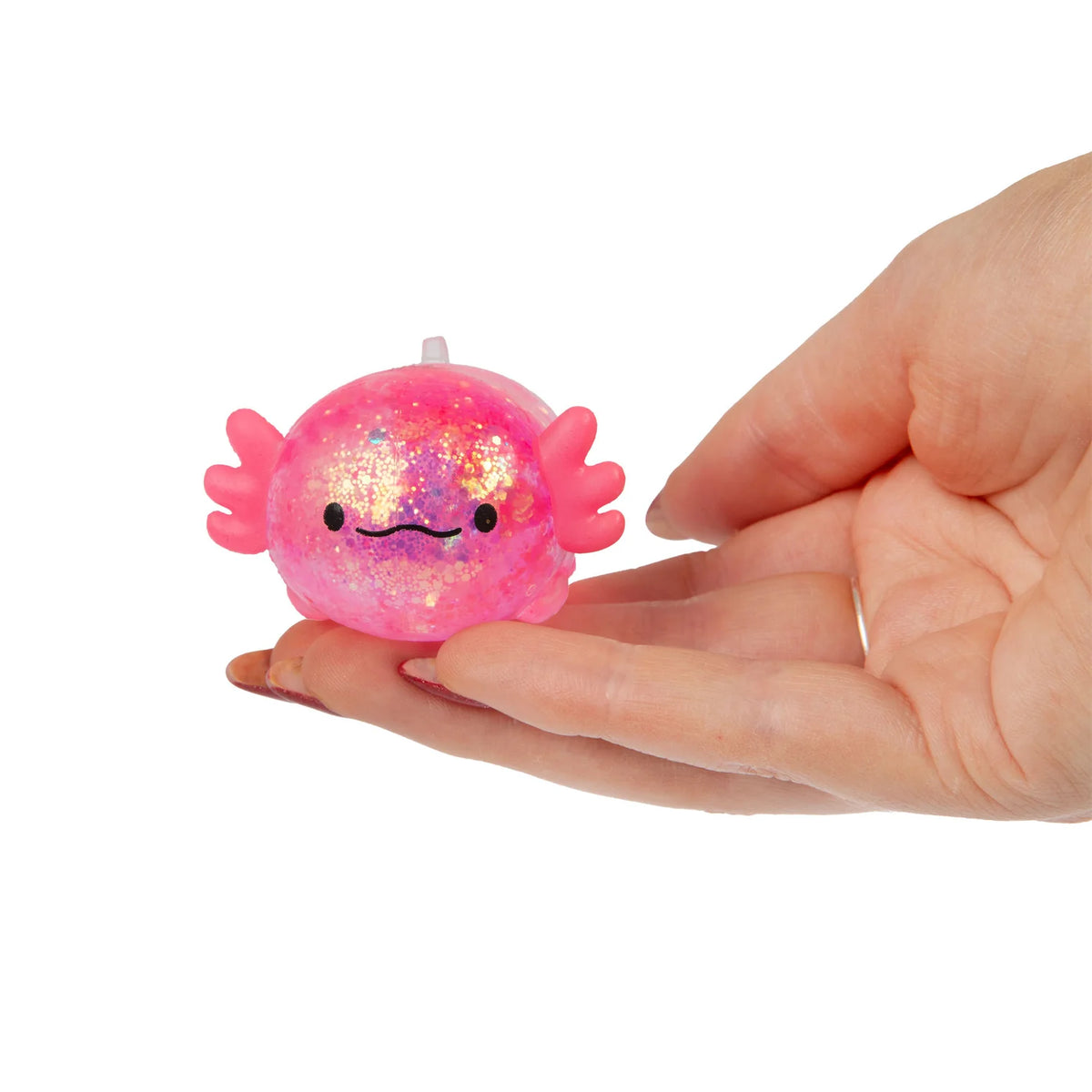 Pink mini sugar axolotl with a smiling face held in a hand against a white background