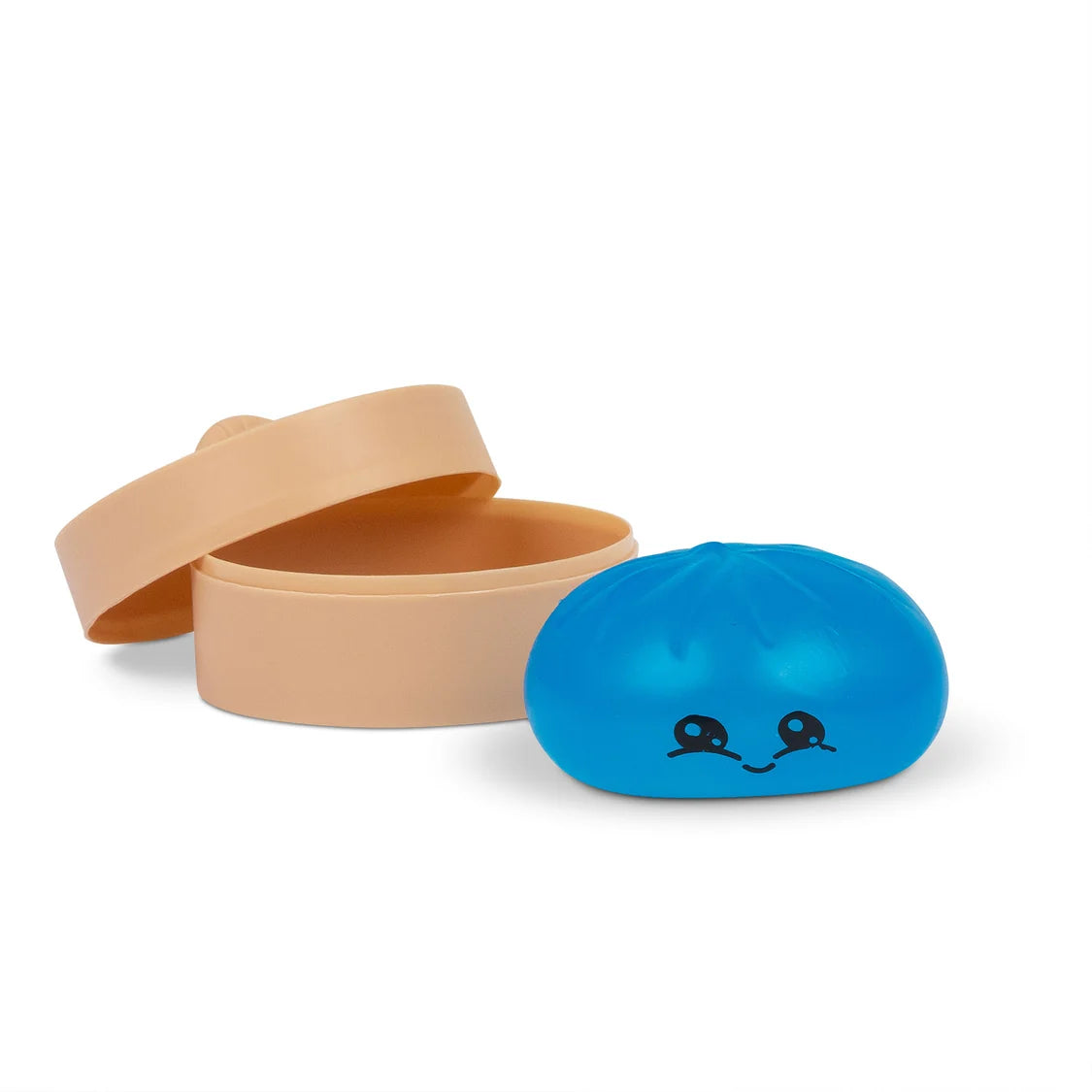 Blue sugar dumpling with a face design next to beige containers on a white background