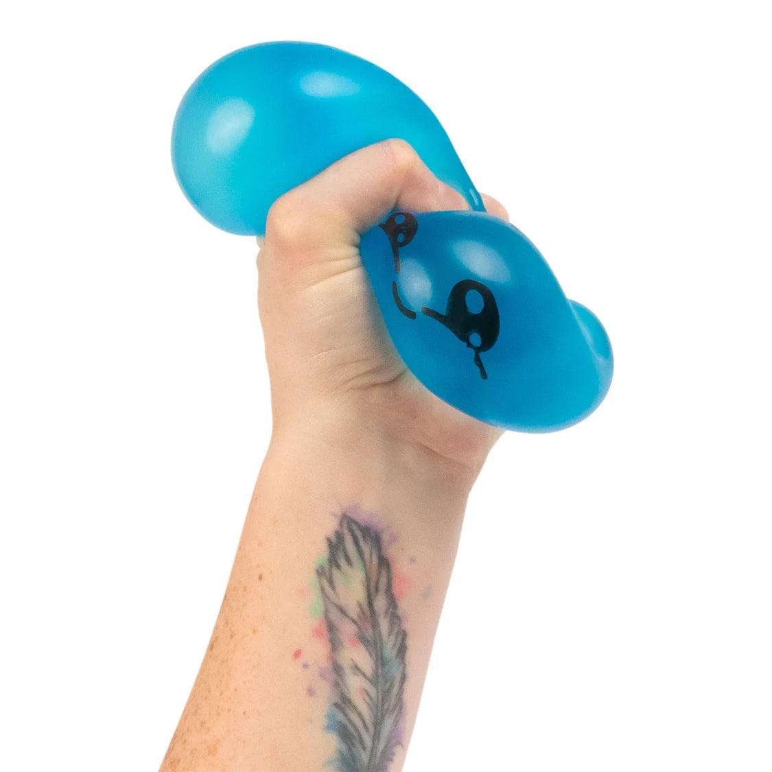 Hand holding a blue sugar dumpling with a white background