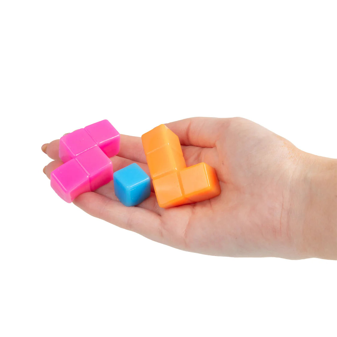 Hand holding colorful squishy puzzle cube on a white background
