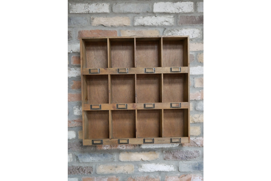 Wooden shelf with multiple compartments against a stone wall background