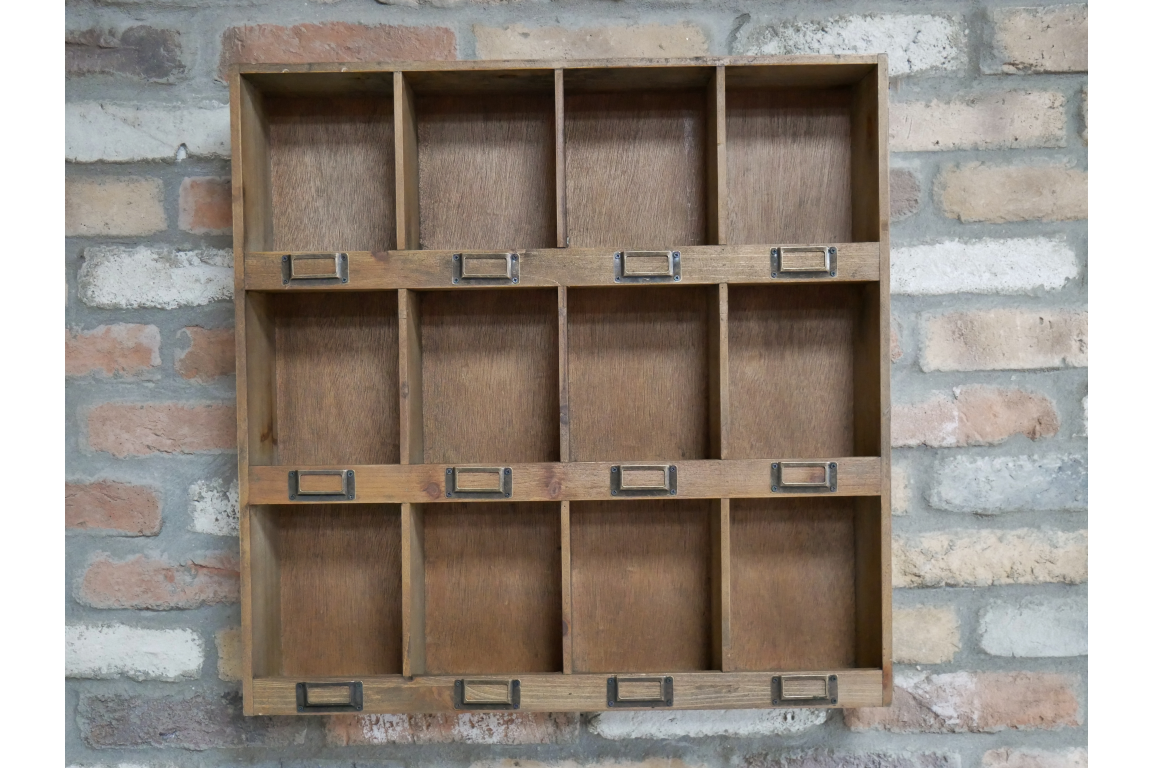 Wooden shelf with multiple compartments against a brick wall.